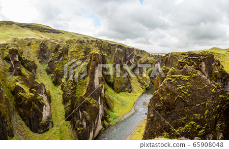 Fjadrargljufur canyon steep cliffs and waters of 65908048
