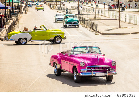 Old vintage retro cars on the road in the center 65908055