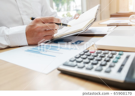 Businessman discussing the charts and graphs showing the results of their successful teamwork. Businessman discussing the charts and graphs showing the results of their successful teamwork. 65908170