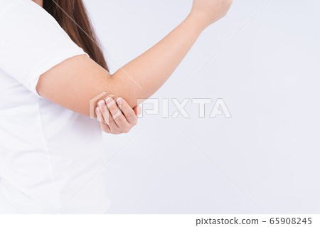 Female touching acute elbow pain on white 65908245