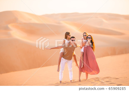 People among dunes in Rub al-Khali desert in United Arab Emirates 65909285