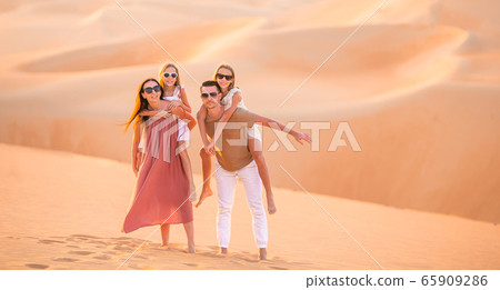 People among dunes in Rub al-Khali desert in United Arab Emirates 65909286