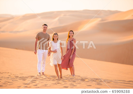 People among dunes in Rub al-Khali desert in United Arab Emirates 65909288