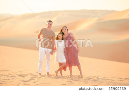 People among dunes in Rub al-Khali desert in United Arab Emirates People among dunes in Rub al-Khali desert in United Arab Emirates 65909289