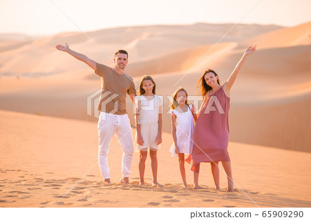 People among dunes in Rub al-Khali desert in United Arab Emirates 65909290