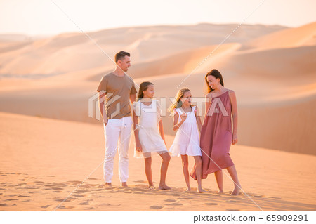 People among dunes in Rub al-Khali desert in United Arab Emirates People among dunes in Rub al-Khali desert in United Arab Emirates 65909291