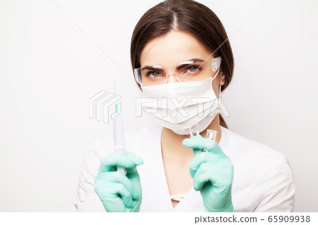 Medicine concept, female doctor typed in syringe vaccine for injection Medicine concept, female doctor typed in syringe vaccine for injection 65909938