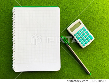 White notebook top view on green table White notebook top view on green table 65910513