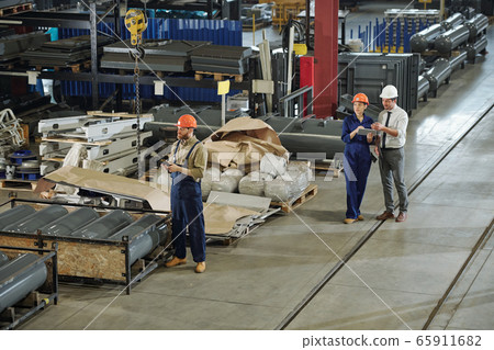 Working at factory warehouse 65911682