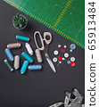 sewing items on a black background from above 65913484