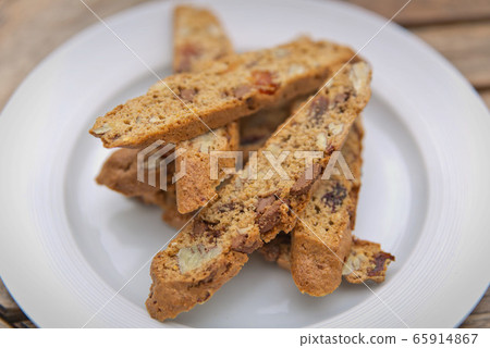 Homemade biscotti cookies with chocolate on a white plate Homemade biscotti cookies with chocolate on a white plate 65914867