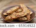 Homemade Biscotti with nuts and dried fruit on a brown plate 65914922