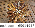 Large brown plate with a variety of homemade biscotti cookies, nuts and coffee beans on a wooden table 65914937