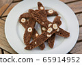chocolate Homemade biscotti with nuts on a white plate on a wooden table 65914952