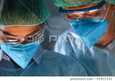 Concentrated medical workers in work Concentrated medical workers in work 65915181