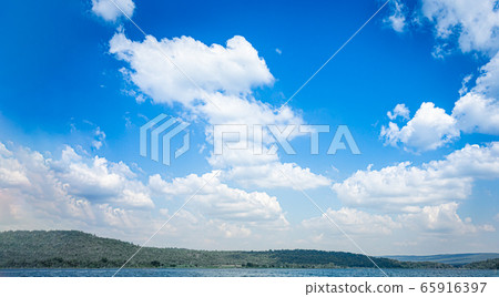 Blue sky and white clouds on the mountain and lake Blue sky and white clouds on the mountain and lake 65916397