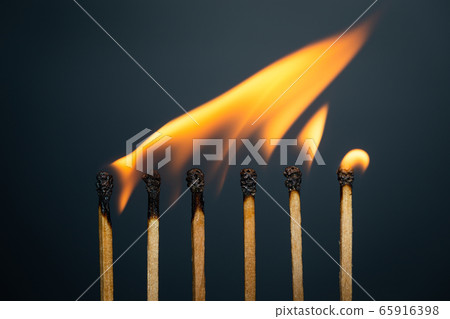 Group match burning on a black background 65916398
