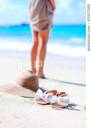 Young woman sunbathing on white beach. Legs. Young woman sunbathing on white beach. Legs. 65917088