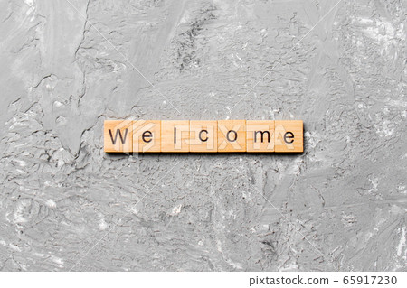 WELCOME word written on wood block. WELCOME text 65917230
