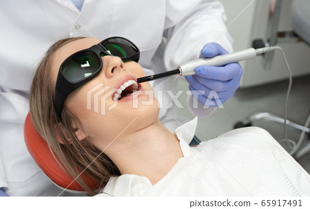 Using a modern method of laser teeth treatment Using a modern method of laser teeth treatment 65917491