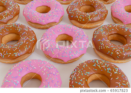3D Render - Baked strawberry frosting donuts and chocolate donuts with icing sprinkle on top. 3D Render - Baked strawberry frosting donuts and chocolate donuts with icing sprinkle on top. 65917823