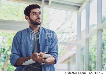 A man thinking and writing his idea at note book A man thinking and writing his idea at note book 65918737
