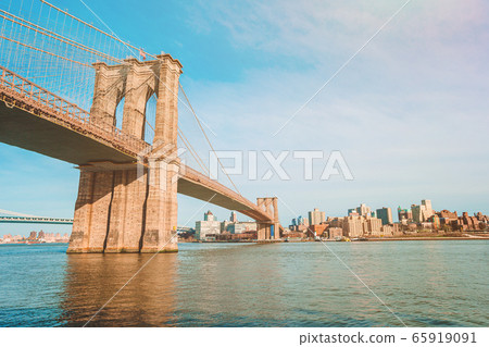 Brooklyn Bridge over river viewed from New York City. Brooklyn Bridge over river viewed from New York City. 65919091