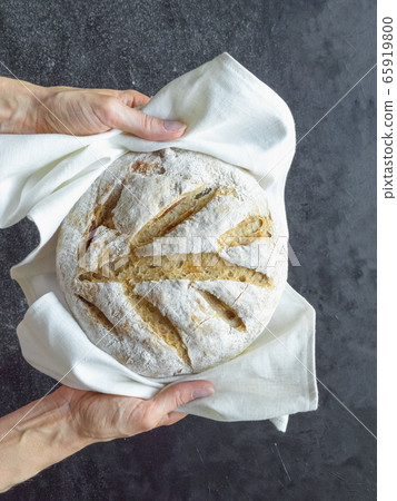 No knead baked bread in a hand No knead baked bread in a hand 65919800