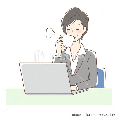 A woman drinking coffee in front of a computer 65920146
