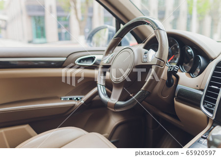 View of the interior of a modern automobile showing the dashboard. 65920597