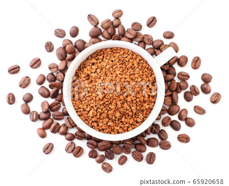 Instant coffee in a cup around coffee beans on a Instant coffee in a cup around coffee beans on a 65920658