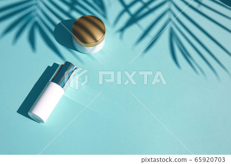 Cosmetic natural products on pastel blue background. Notebook for inscription 65920703