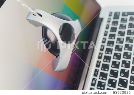 photographer monitor with Display Calibration in the office, tools for calibrating colors. photographer monitor with Display Calibration in the office, tools for calibrating colors. 65920925