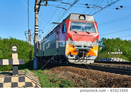 electric locomotive moves on rails between two electric locomotive moves on rails between two 65921408