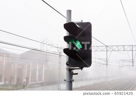 railroad rails lurking in fog, in the foreground railroad rails lurking in fog, in the foreground 65921420