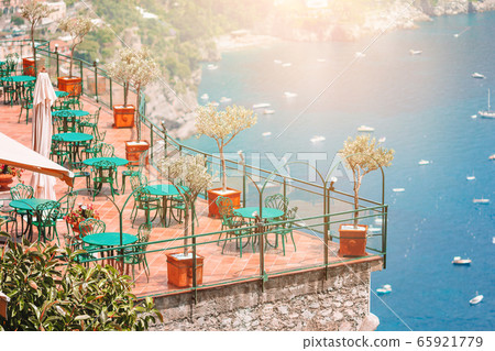 Summer empty outdoor cafe in a tourist place in Italy Summer empty outdoor cafe in a tourist place in Italy 65921779