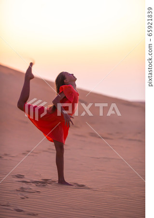Girl among dunes in Rub al-Khali desert in United Arab Emirates 65921839