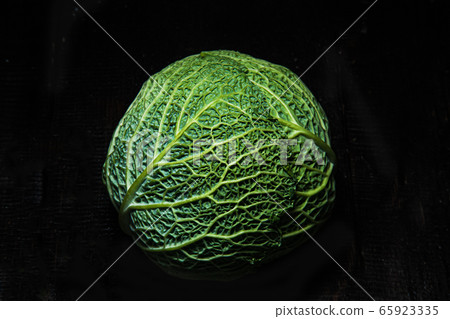 Savoy cabbage on a dark background close-up. Leaf, agriculture. 65923335