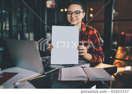 Happy freelancer showing blank document. Work on freelance Happy freelancer showing blank document. Work on freelance 65923337