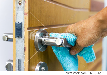 Prevention cleaning Door handles by Disinfectant solution for killing corona virus on touching surfaces, concept coronavirus COVID19. 65924216