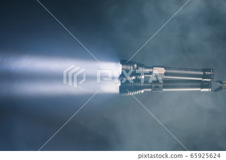 ray of pocket flashlight in smoke, copy-space ray of pocket flashlight in smoke, copy-space 65925624