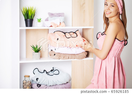 Pretty girl in a towel dress with perfect skin after home spa treatments Pretty girl in a towel dress with perfect skin after home spa treatments 65926185