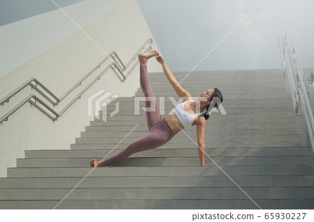 Street Yoga - Asian Chinese Woman doing yoga in the street 65930227