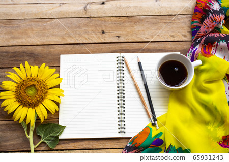notebook planner for business work with hot coffee, yellow flowers sunflower ,scarf arrangement flat lay style 65931243