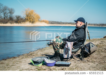 Feeder fishing. Male fisherman fishing at sun day Feeder fishing. Male fisherman fishing at sun day 65931515
