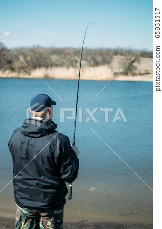 Feeder fishing. Male fisherman fishing at sun day Feeder fishing. Male fisherman fishing at sun day 65931517