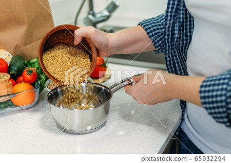 Woman is cooking Ancient Grains Porridge. Heirloom 65932294