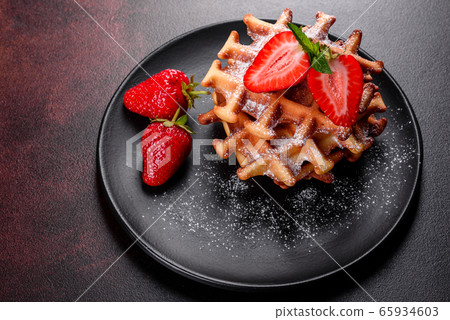 Delicious fresh baked belgian waffles with berries Delicious fresh baked belgian waffles with berries 65934603