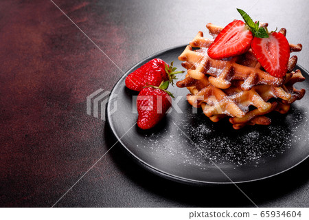 Delicious fresh baked belgian waffles with berries Delicious fresh baked belgian waffles with berries 65934604