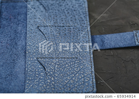 Blue leather wallet on a black textured 65934914